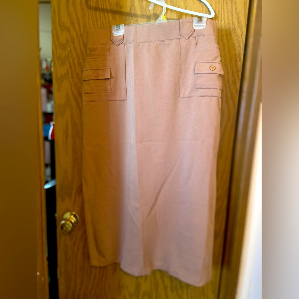Long tan skirt with multiple pockets.